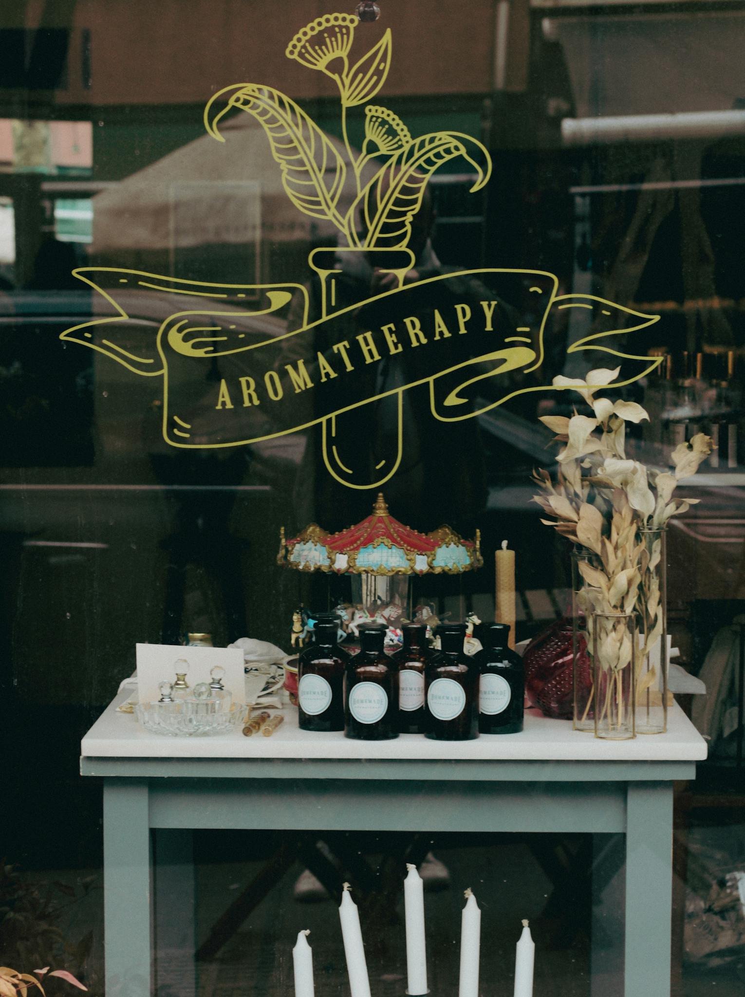 A beautifully arranged aromatherapy storefront with candles, essential oils, and decor.