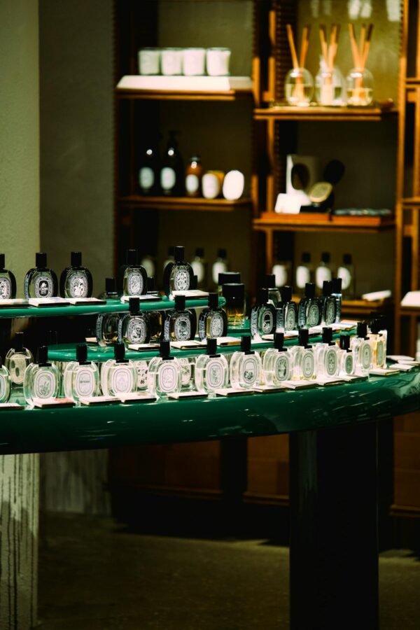 An elegant arrangement of perfume bottles in a boutique store in Shanghai, China. Sophisticated ambiance with selective lighting.